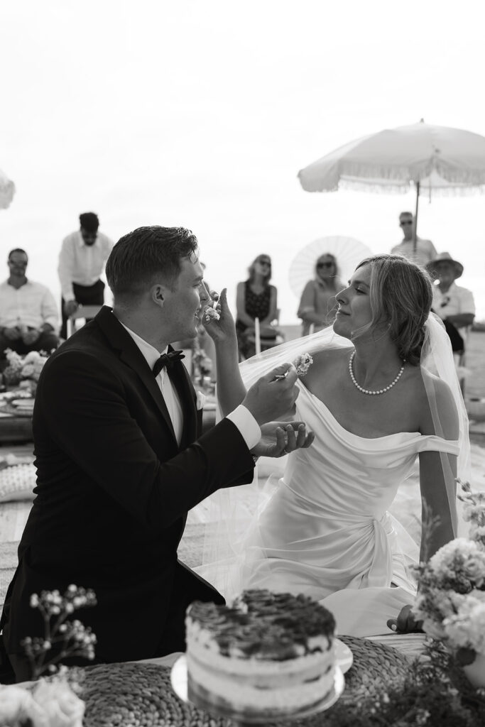 bride and groom sharing their first slice of cake after wedding ceremony