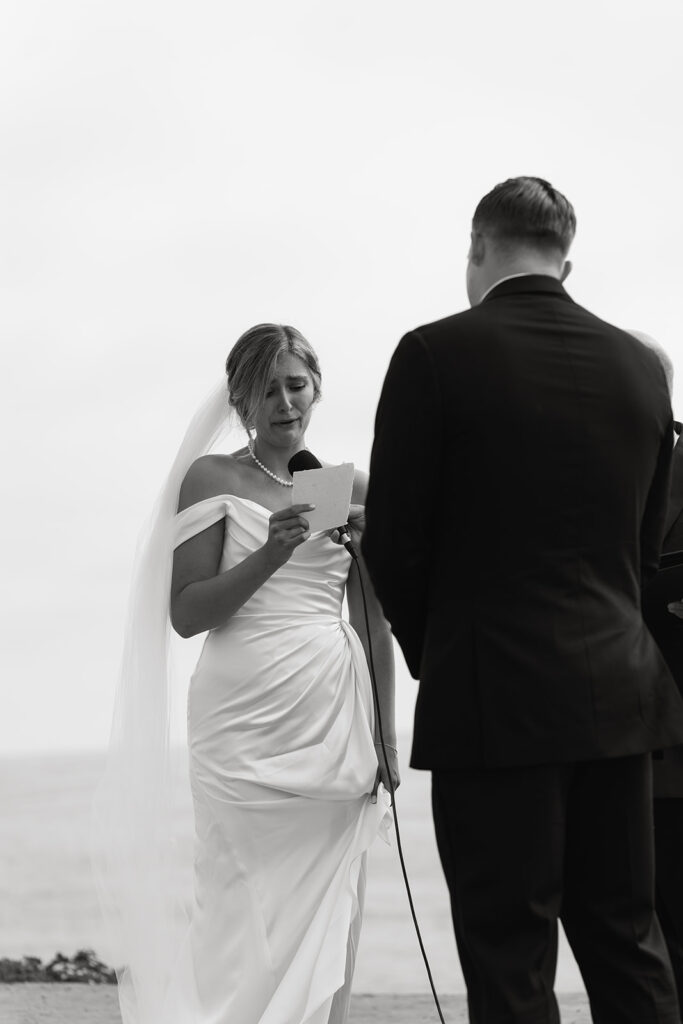 bride and groom reading vows during their sunset cliffs micro wedding