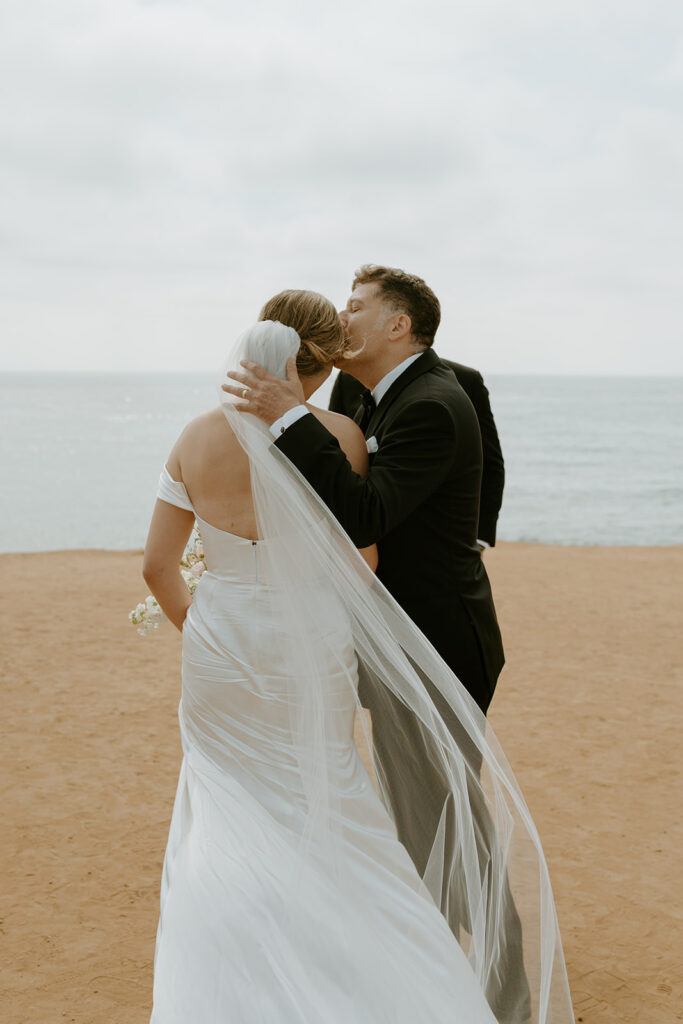 bride walking down the aisle at beach wedding at sunset cliffs