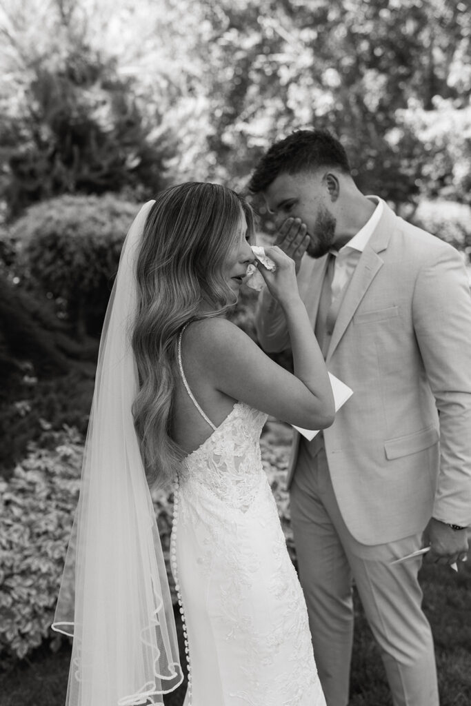 bride and groom sharing a cry after heartfelt handwritten vows