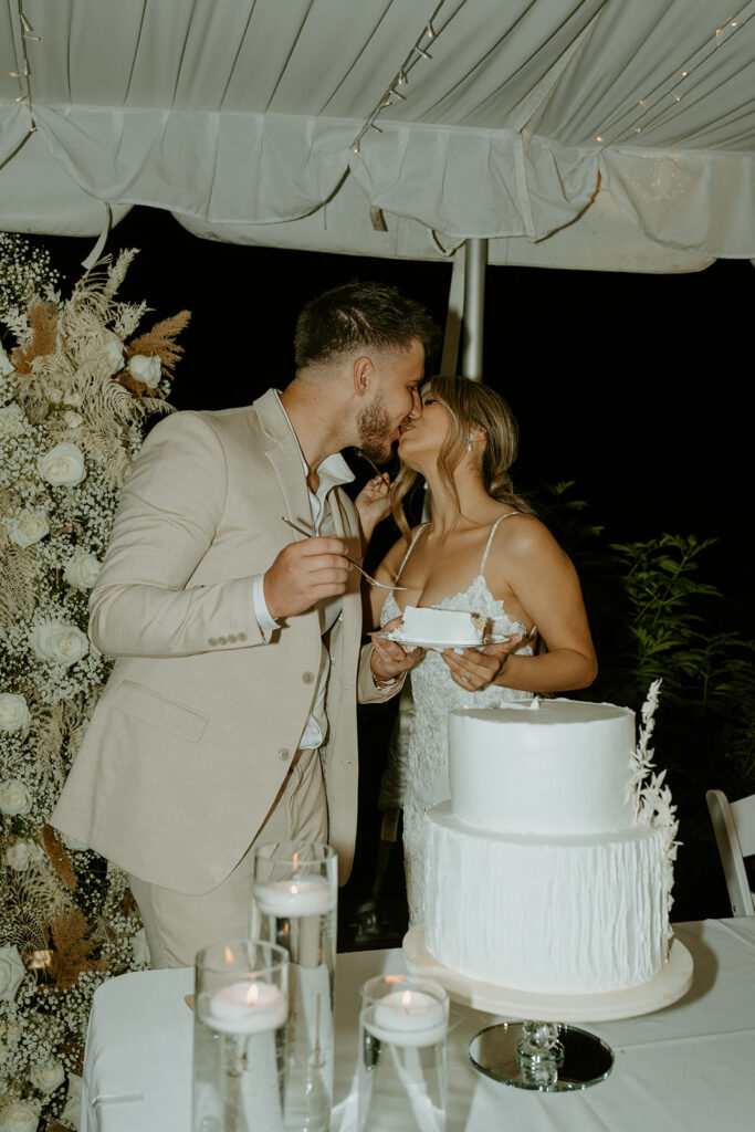 bride and groom toasting and cutting cake