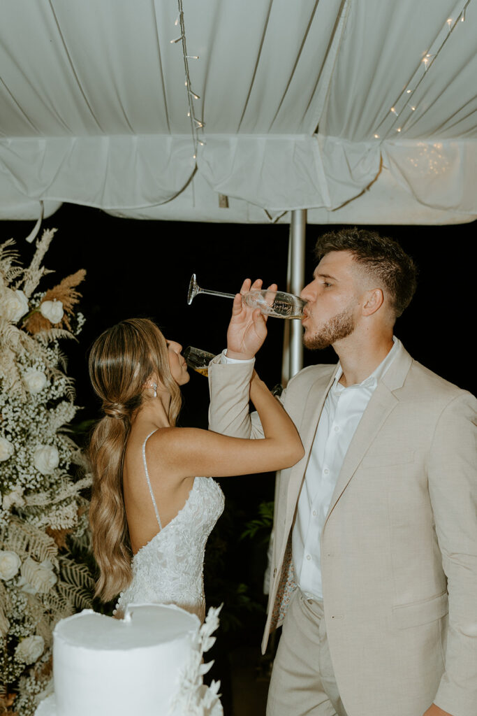 bride and groom toasting and cutting cake