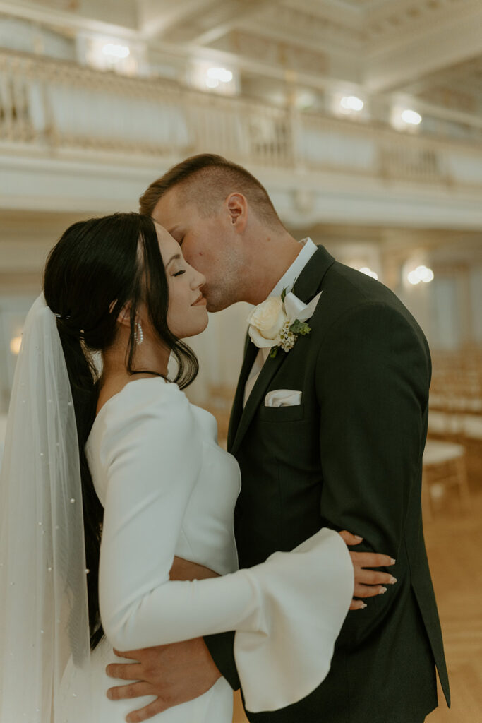 groom kissing brides cheek