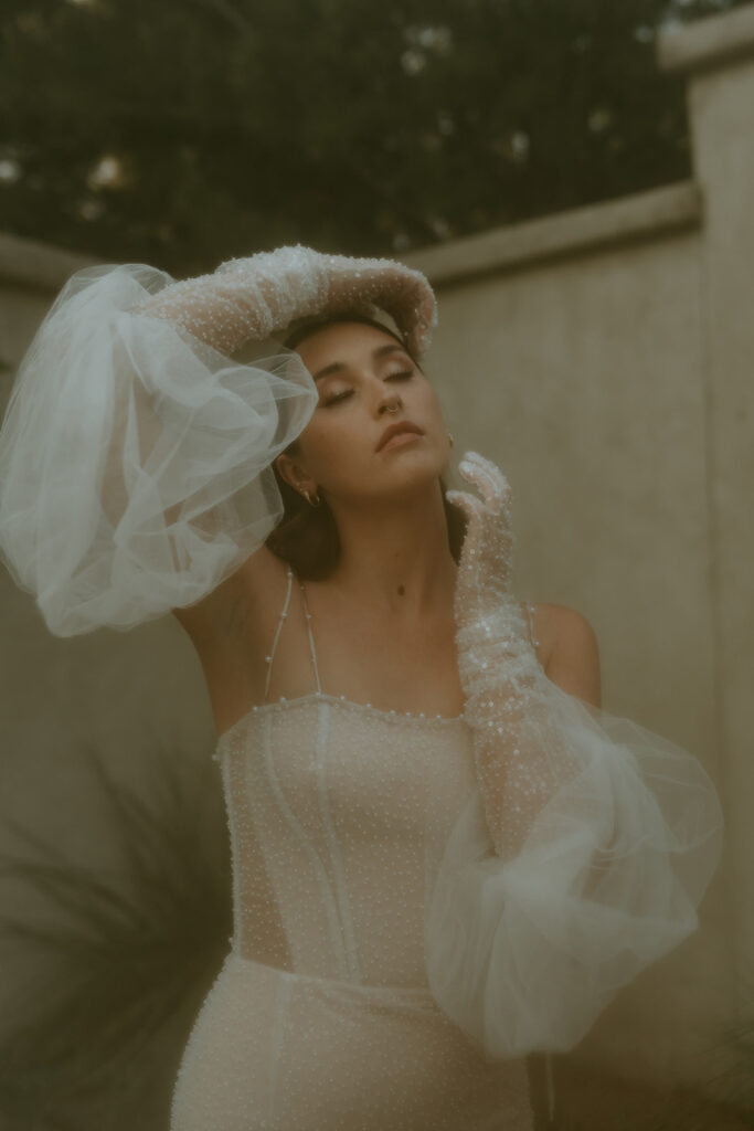 bride wearing a puff sleeve wedding dress with pearl detailing