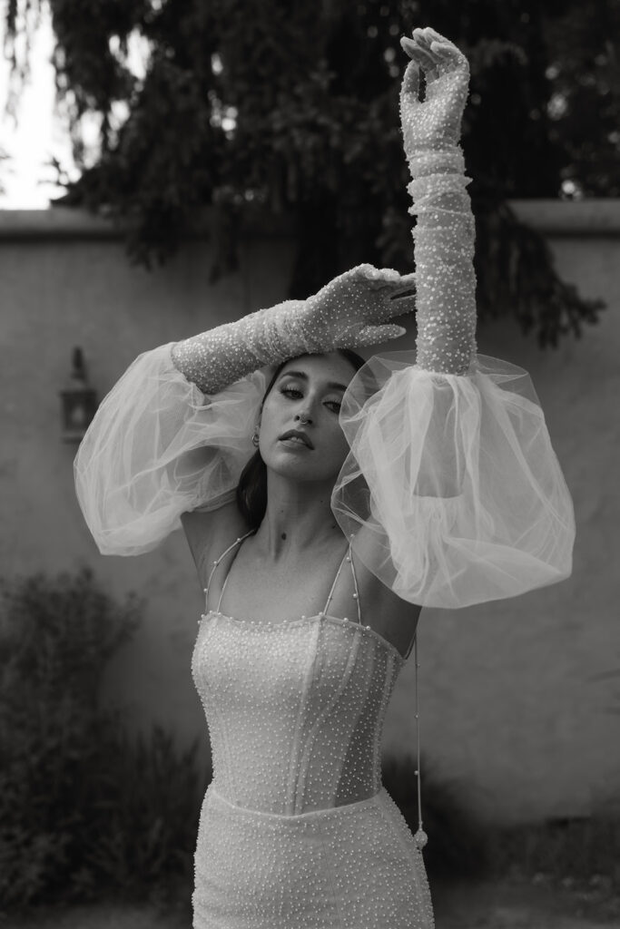 bride wearing a puff sleeve wedding dress with pearl detailing