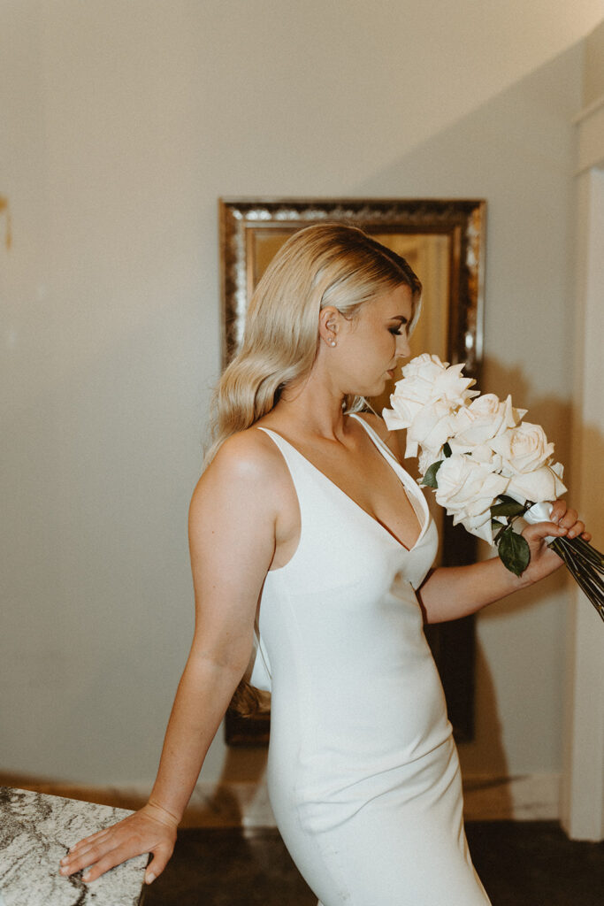 Creative bridal portraits in the mansion bathroom, showcasing the bride's unique style.