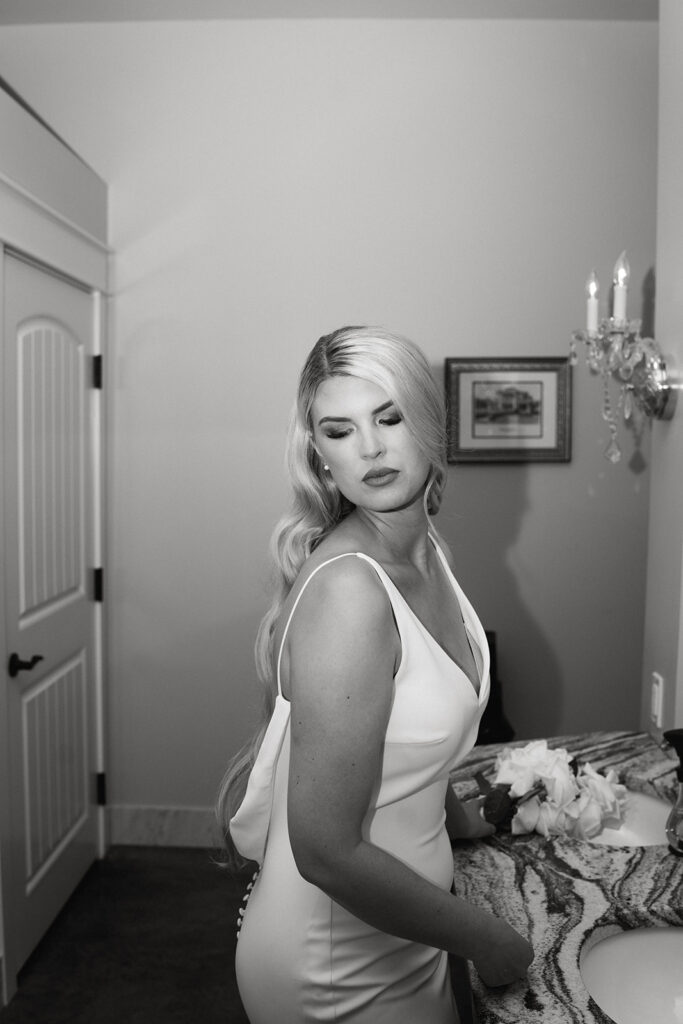 Creative bridal portraits in the mansion bathroom, showcasing the bride's unique style.