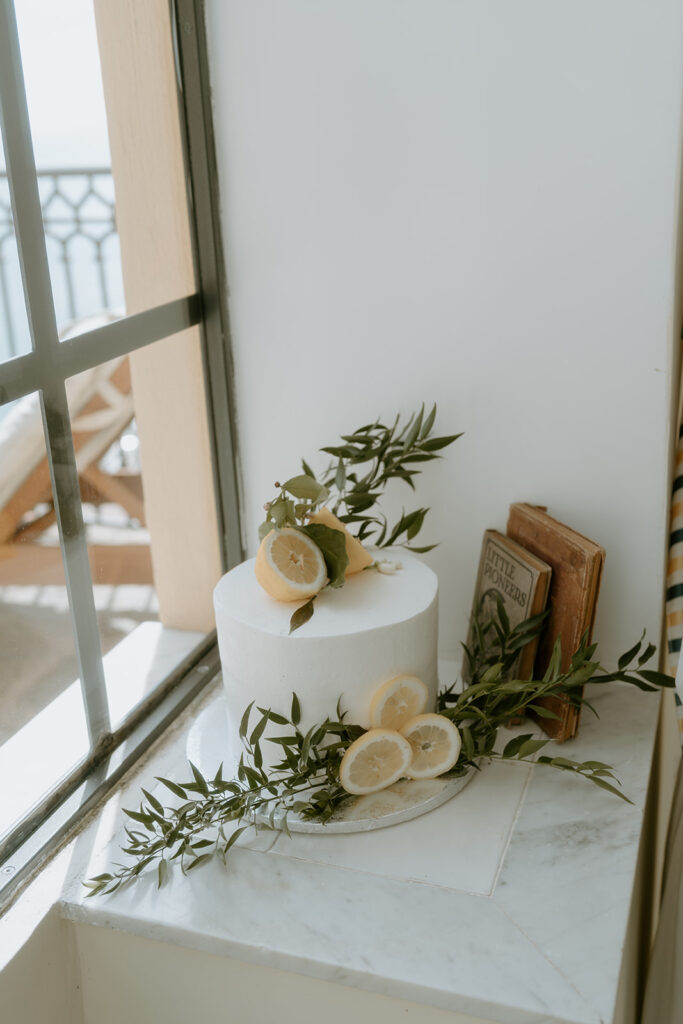 A close-up of a lemon-accented wedding cake, showcasing the citrusy details.