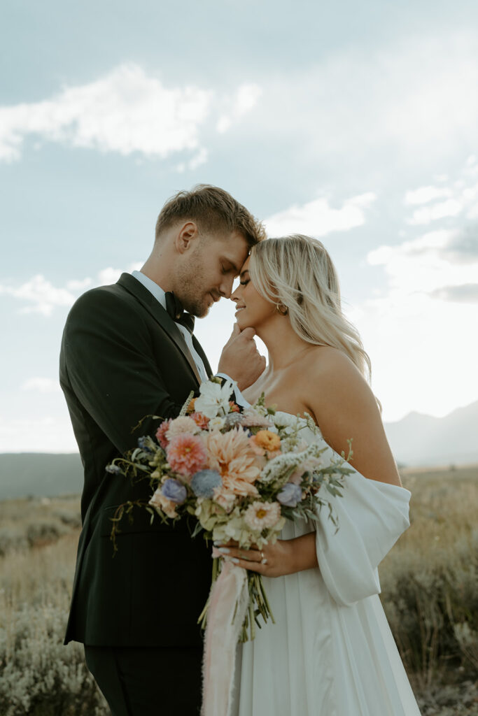 bride holding a wildflower elopement bouquet