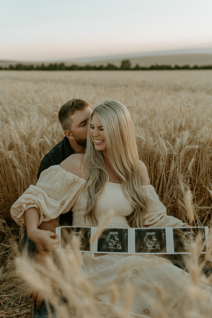 Haley and Tate share a tender moment, the setting sun creating a romantic backdrop for their pregnancy reveal photo shoot.