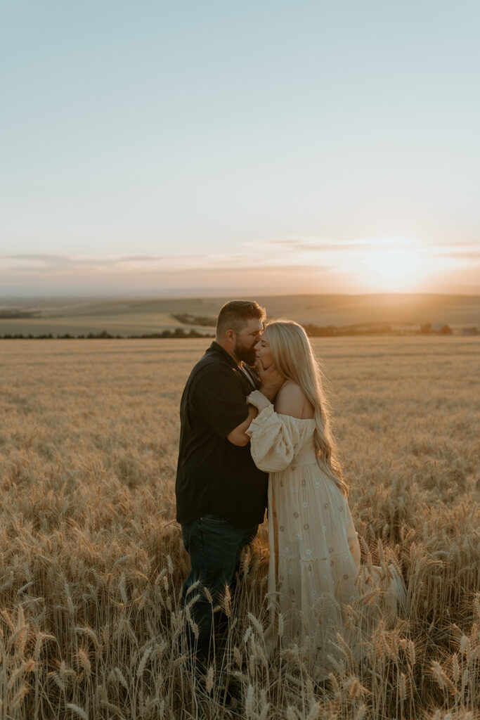 Haley and Tate share a tender moment, the setting sun creating a romantic backdrop for their pregnancy reveal photo shoot.