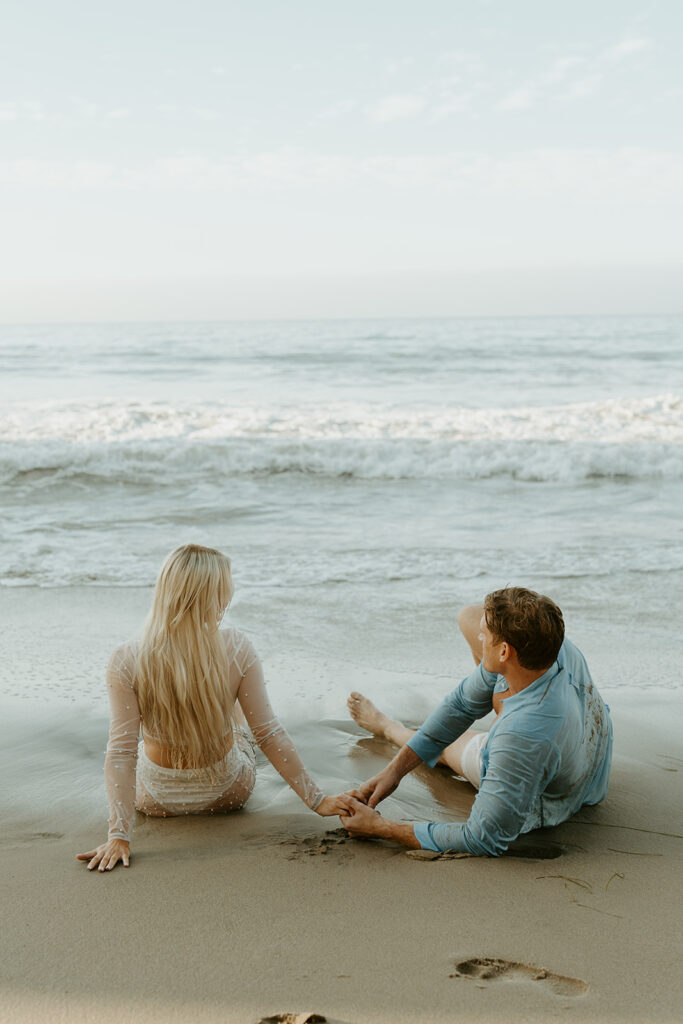 Playful Malibu engagement photos at sunrise